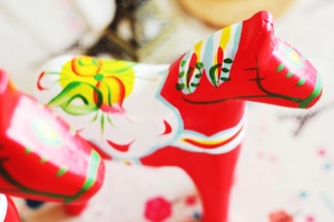 Close-up of hand-painted Swedish Dala Horse decor with traditional floral Kurbits patterns
