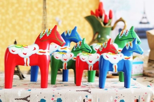 Close-up of colorful hand-painted Swedish Dala horses in red, blue, and green wood