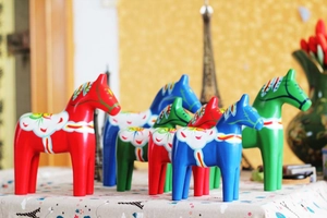 Close-up of hand-painted Swedish Dala horses with classic Kurbits floral patterns