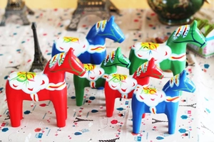 Close-up of hand-painted Swedish Dala Horse figurines with colorful Kurbits folk art patterns