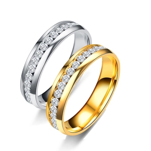 Detailed view of silver and gold stainless steel rings with channel-set cubic zirconia