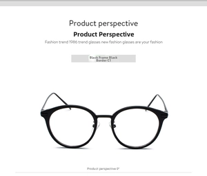 Close-up of retro black round frame glasses with slim metal arms and clear lenses