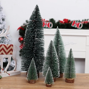 Snow-flocked mini Christmas trees with wooden bases for festive tabletop decoration
