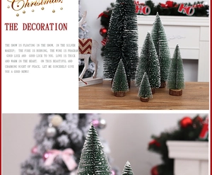 Miniature snow-covered pine trees set on wooden bases for festive tabletop decor