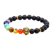 Detail of black lava stone chakra bracelet featuring a golden lion head and seven colorful beads