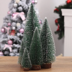 Set of 4 mini flocked green Christmas trees with wooden bases on a festive table