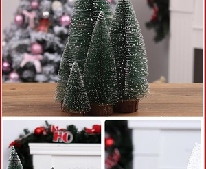 Macro view of mini flocked Christmas trees with snow effects and rustic wooden bases