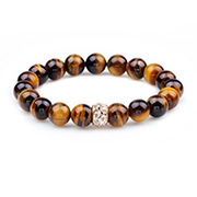 Macro detail of tiger eye stone beads with a crystal encrusted metallic spacer bead