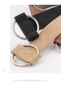 Macro detail of minimalist women's suede belts with silver round buckles and smooth textures