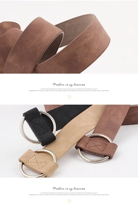 Detail of round silver buckles and stitching on black, tan and brown leather belts