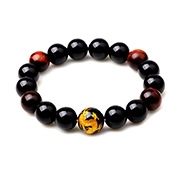 Detailed view of beaded bracelet with black obsidian, tiger eye stones and golden dragon bead