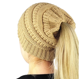 Khaki knit ponytail beanie for winter with an opening for long hair shown on model