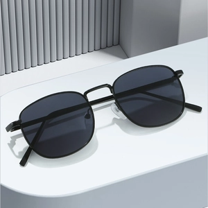 Fashionable square metal frame sunglasses with dark polarized lenses on a minimalist stand