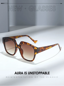 Macro detail of tortoiseshell leopard print sunglasses frame with brown gradient lenses