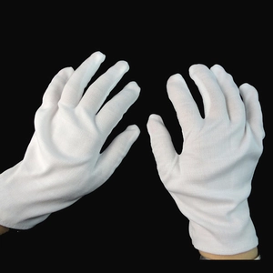 Classic white cotton performance gloves for magicians and clowns on a black background