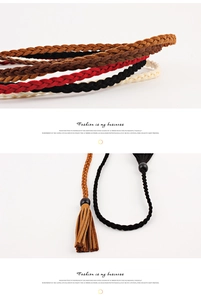 Detail of woven suede belts with fringe tassels in brown, black, red, and beige colors