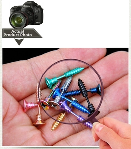 Detailed macro view showing diverse colorful screw head stud earrings in punk industrial style
