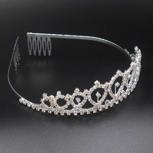 Detailed view of a silver crystal tiara with side combs on a sleek black background