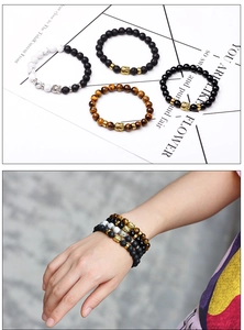 Detail of 8mm lava stone, tiger eye, and marble bead bracelets with metal Buddha head charms