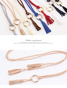 Detail of hand-woven tassels and golden ring buckle on thin braided waist rope