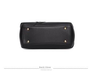 Detail view of the black leather bag bottom with four protective gold metal studs