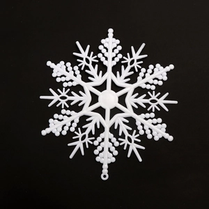 White hollow plastic snowflake ornaments for Christmas tree and festive holiday scene decor