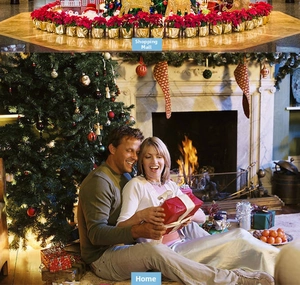 Christmas scene layout with red poinsettia plants, golden reindeer, and holiday tree decor