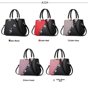 Detail view of colorful floral embroidery on high-quality synthetic leather handbags