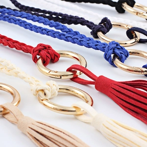 Braided suede thin waist belt with golden metal spring buckle and tassel details