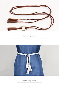 Detail of handmade braided waist rope with tassels and gold ring for summer dresses