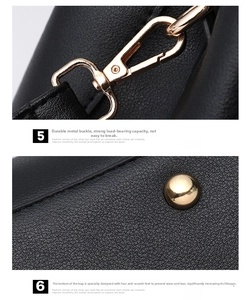 Detail of durable gold metal hardware and protective bottom studs on black leather bag
