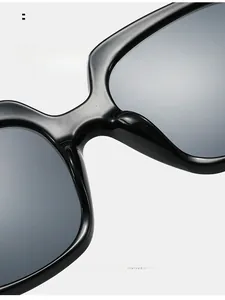 Detail of comfortable integrated nose pads on glossy black flat top sunglasses