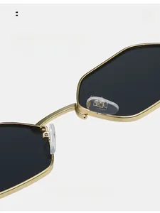 Macro detail of comfortable clear silicone nose pads on gold metal polygon sunglasses