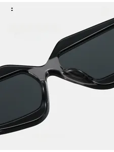 Detail of the widened integrated nose pads on black geometric color-block sunglasses