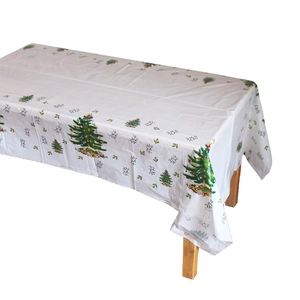 Nappe de Noël jetable blanche avec motifs de sapins et flocons sur une table en bois