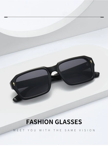 Detail view of square black sunglasses with gold arrow metal accents on corners