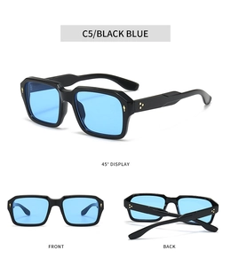 Detail view of square sunglasses with black frames, blue lenses and golden metal rivets