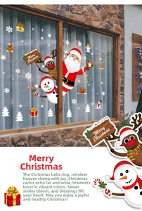 Close-up of festive Christmas window decals featuring Santa, reindeer and snowflakes
