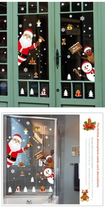 Detailed view of Merry Christmas window decals with Santa Claus and reindeer on glass