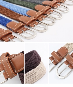 Detail view of woven elastic belts in various colors with silver buckles and leather loops