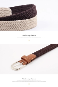 Close-up of braided elastic belts in dark brown and beige with silver buckles