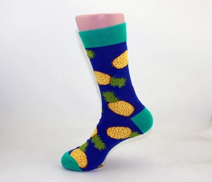 Detail of cotton crew sock featuring blue pineapple patterns and turquoise contrast heel