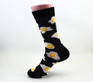 Detail of cotton crew socks featuring creative fried egg pattern on a black base