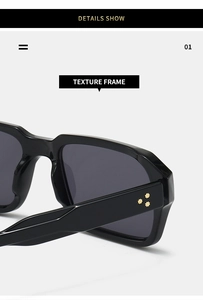 Detailed close-up of shiny black sunglasses frame featuring three gold star rivets