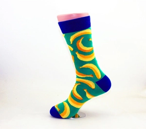 Detail of green cotton crew socks featuring yellow banana patterns and navy color-blocking