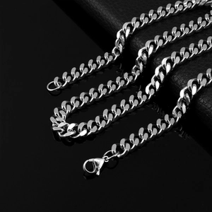 Detail shot of silver Cuban link chain with polished finish and lobster claw clasp closure