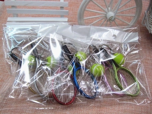 Close-up of mini tennis racket and ball keychains in multi-color assorted packaging