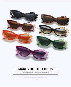 Flat lay of cat eye sunglasses in multiple colors with textured crystal geometric frames