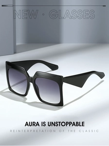 Detail of square oversized sunglasses with thick black frames and gradient grey lenses
