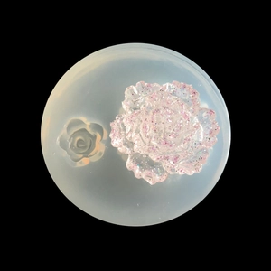 Silicone flower mold for DIY resin jewelry making with a pink glitter floral pendant